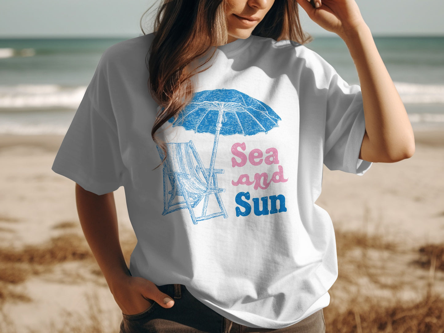 White t-shirt with "Sea and Sun" text and beach scene graphic.