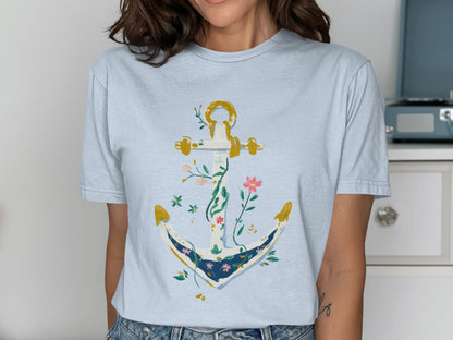 Light blue t-shirt featuring a white anchor adorned with colorful flowers and vines.