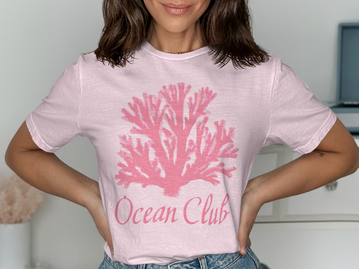 Pink t-shirt with a pink coral graphic and "Ocean Club" text.