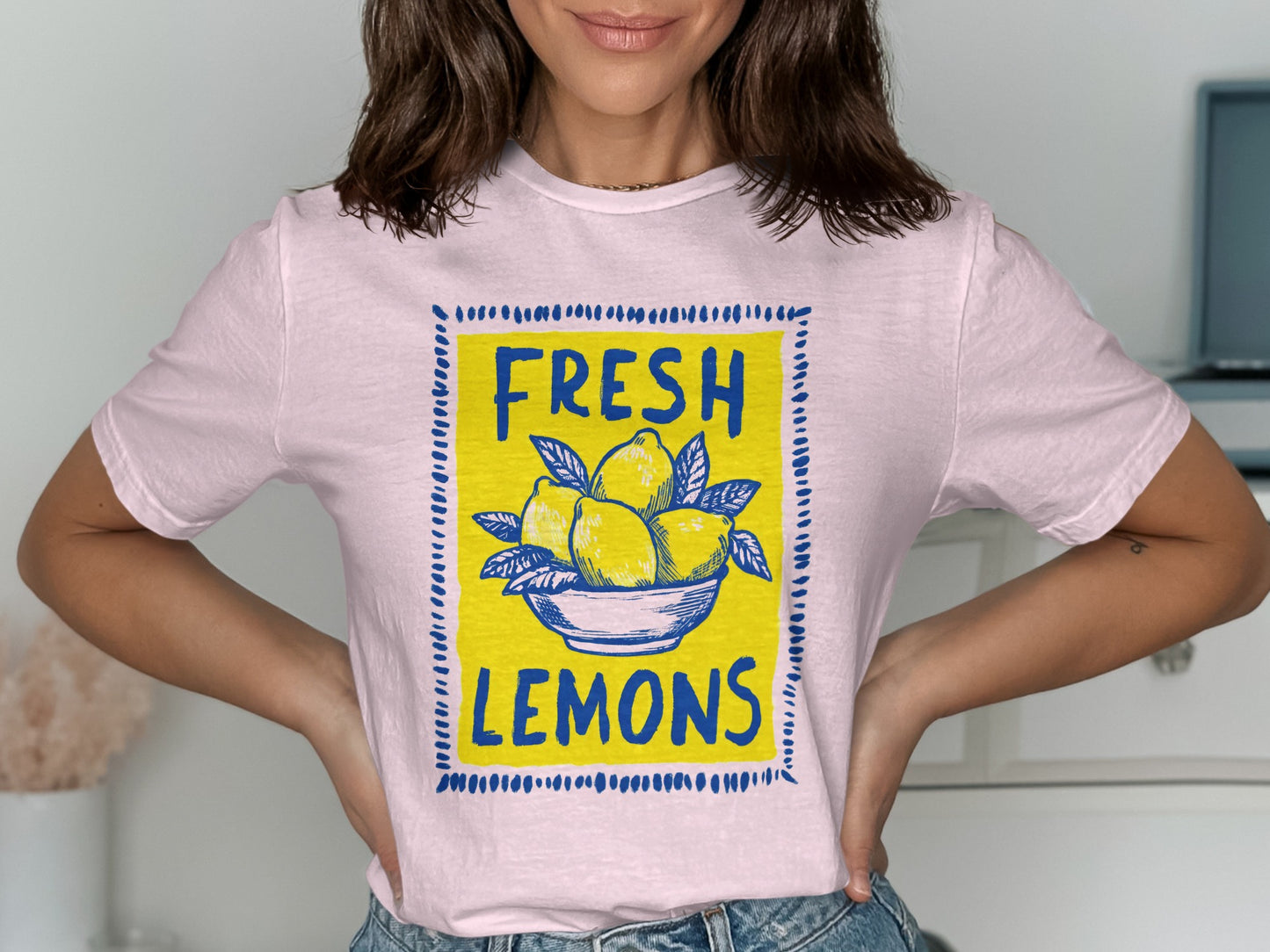 Pink t-shirt with blue square frame featuring "FRESH LEMONS" and a bowl of lemons.