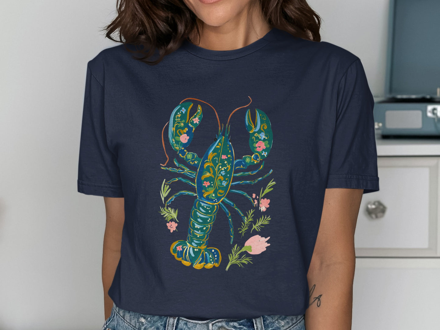 Navy t-shirt with a colorful floral lobster graphic.
