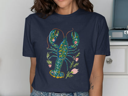 Navy t-shirt with a colorful floral lobster graphic.