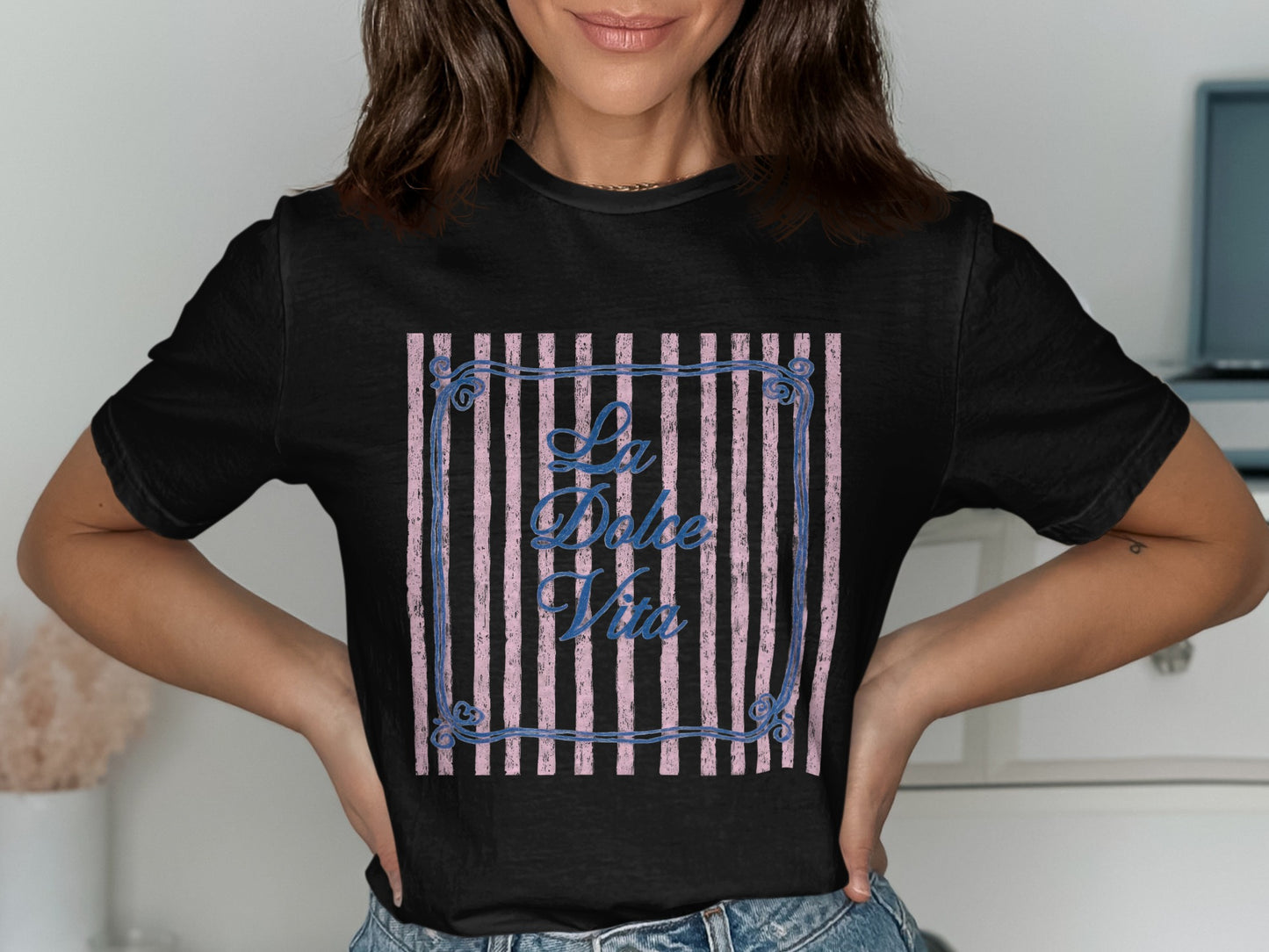 Black t-shirt with "La Dolce Vita" text inside a striped frame.