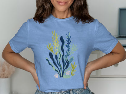 Light blue t-shirt with abstract green and yellow botanical print.