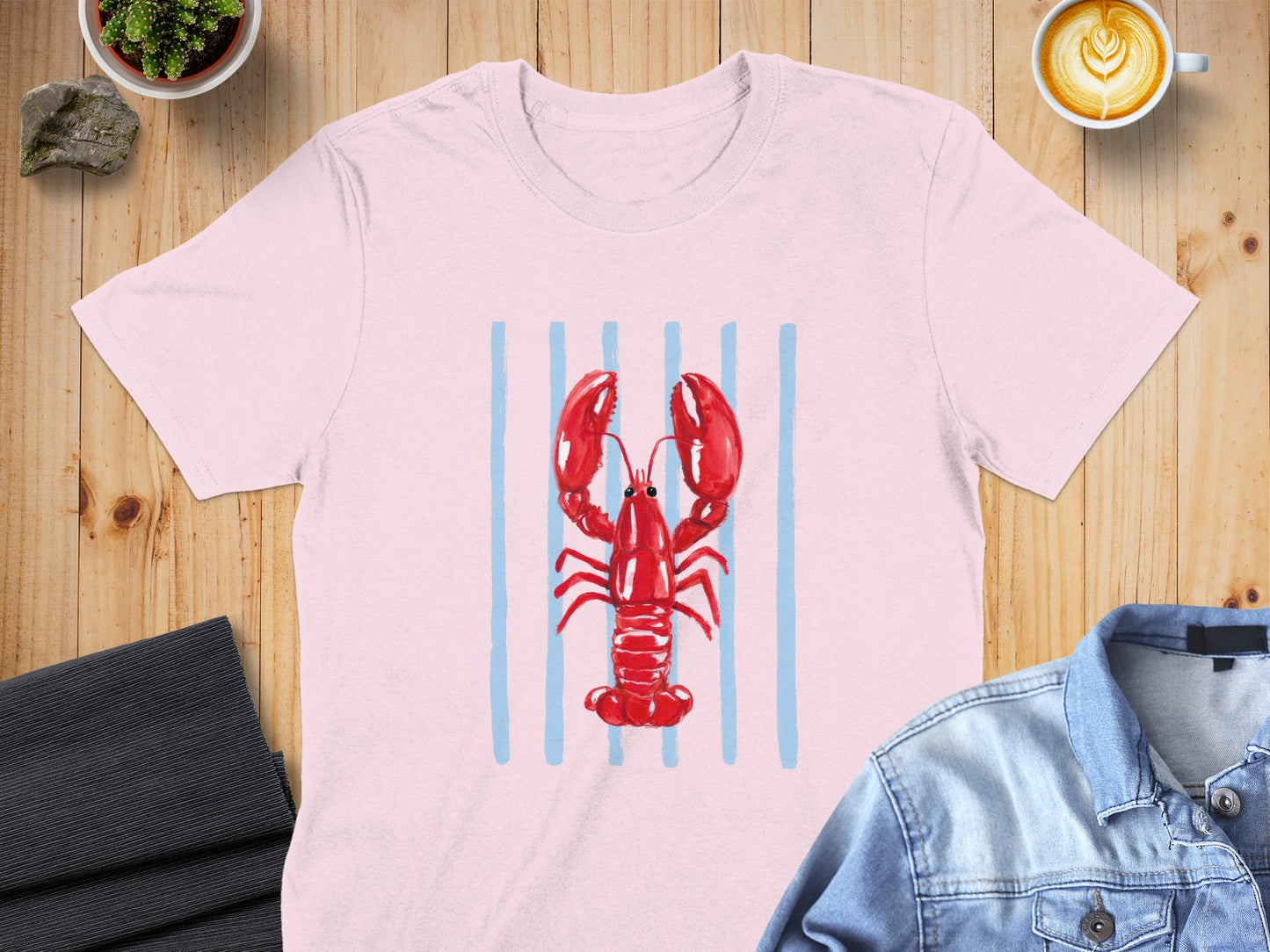 Pink t-shirt with a red lobster and blue stripes design.