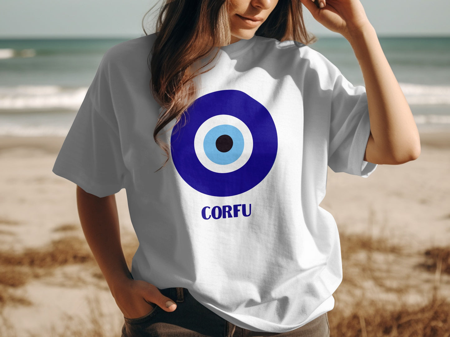 White t-shirt with blue evil eye design and "CORFU" text.