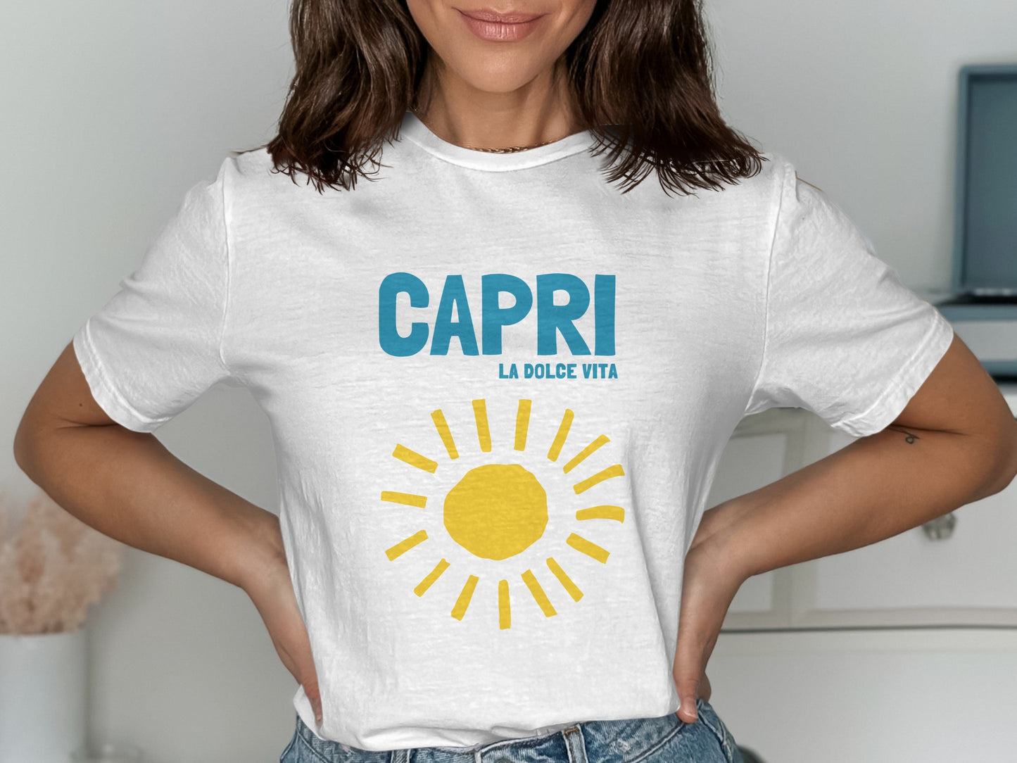 White t-shirt with "CAPRI LA DOLCE VITA" and a yellow sun graphic.