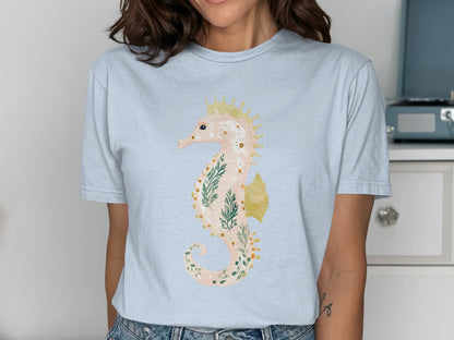 Light blue t-shirt with a watercolor seahorse illustration and crown.