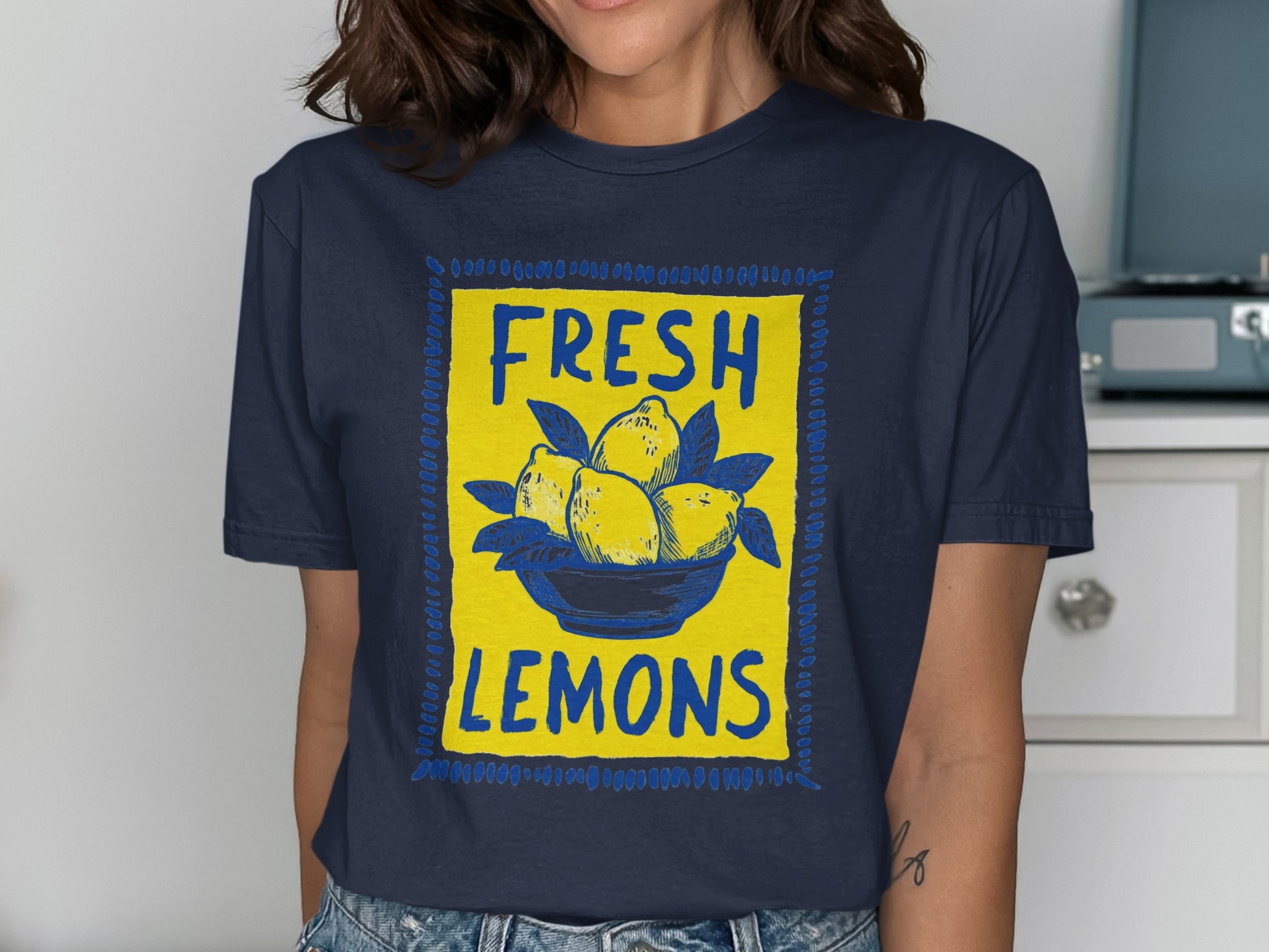 Dark t-shirt with a blue and yellow graphic of lemons in a bowl.
