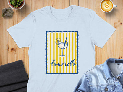 White t-shirt featuring a limoncello glass and slice with yellow and blue stripes.