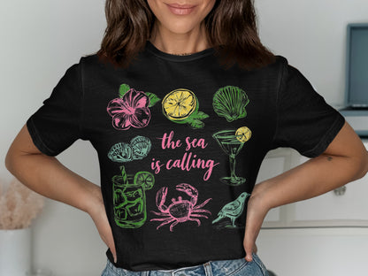 Black t-shirt with tropical illustrations and "the sea is calling" text.