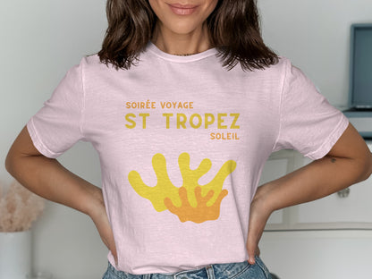 Pink t-shirt with "Soirée Voyage St Tropez Soleil" and yellow coral graphic.
