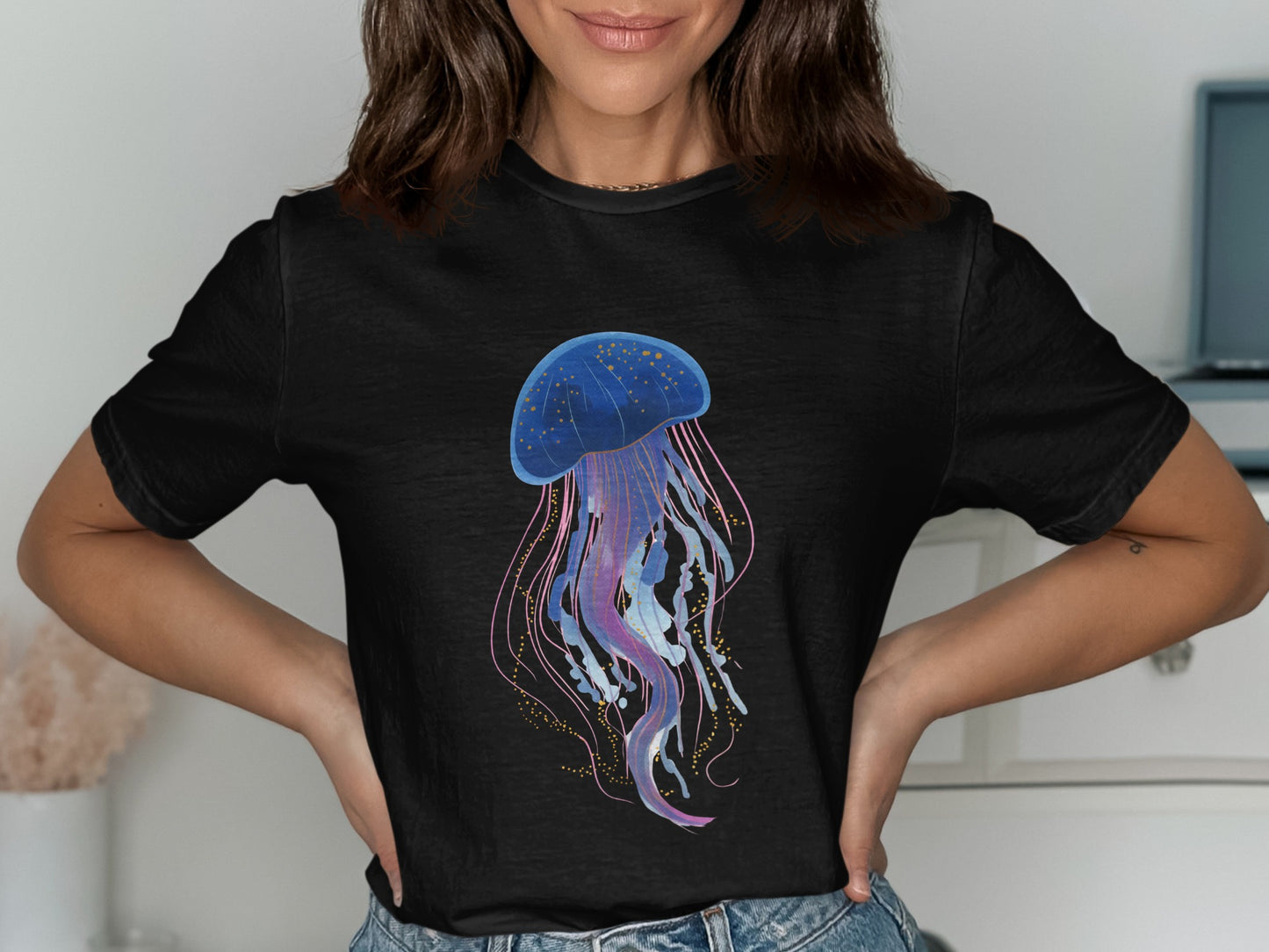 Black t-shirt with a blue jellyfish design with pink and gold accents.