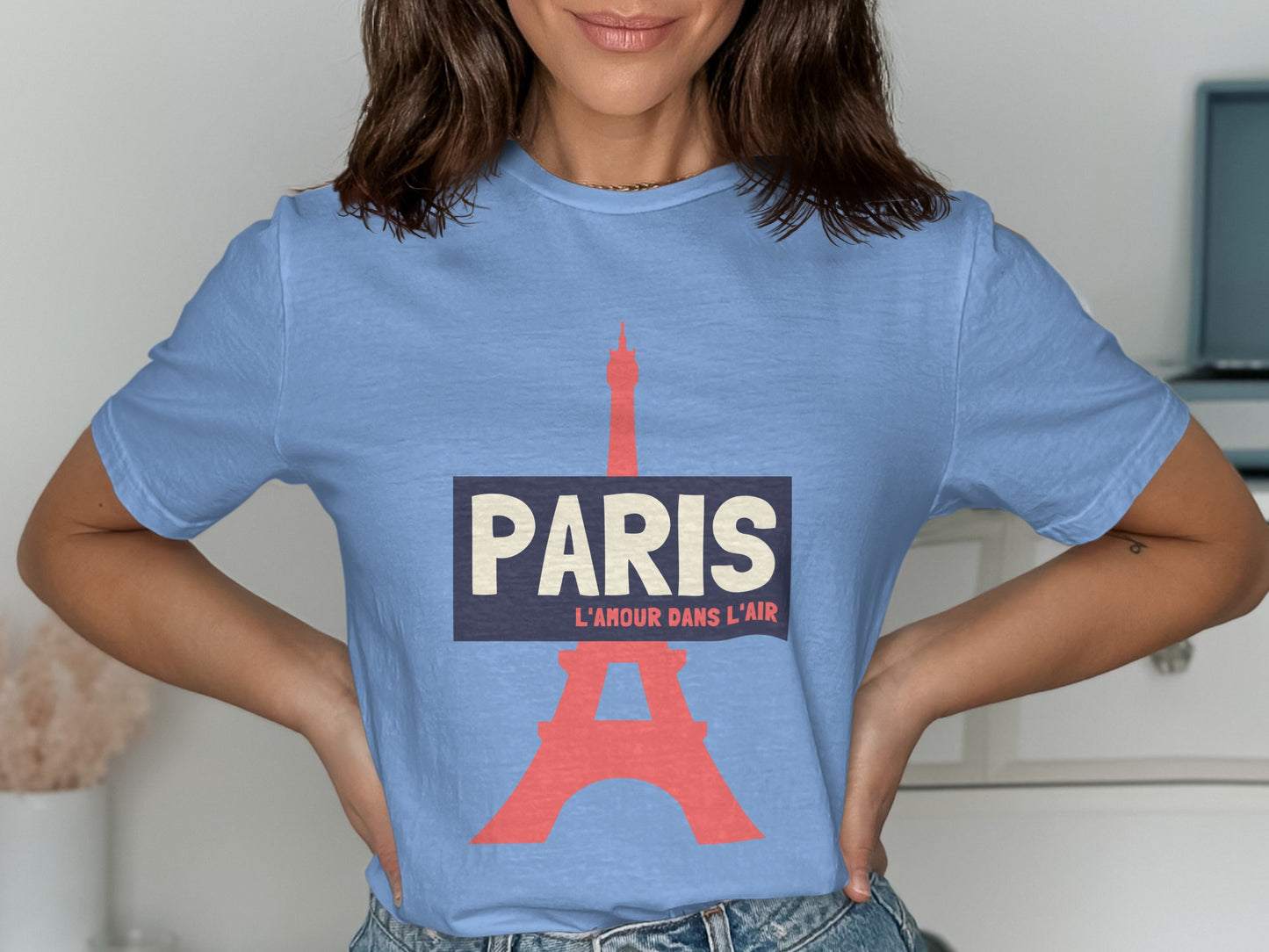 Light blue t-shirt with "PARIS L'AMOUR DANS L'AIR" and Eiffel Tower graphic.