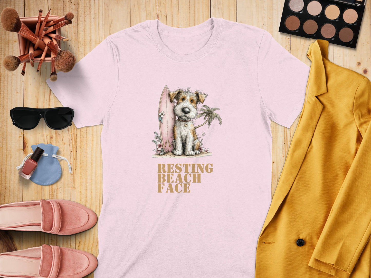 Pink t-shirt with dog and surfboard graphic, "Resting Beach Face" text.