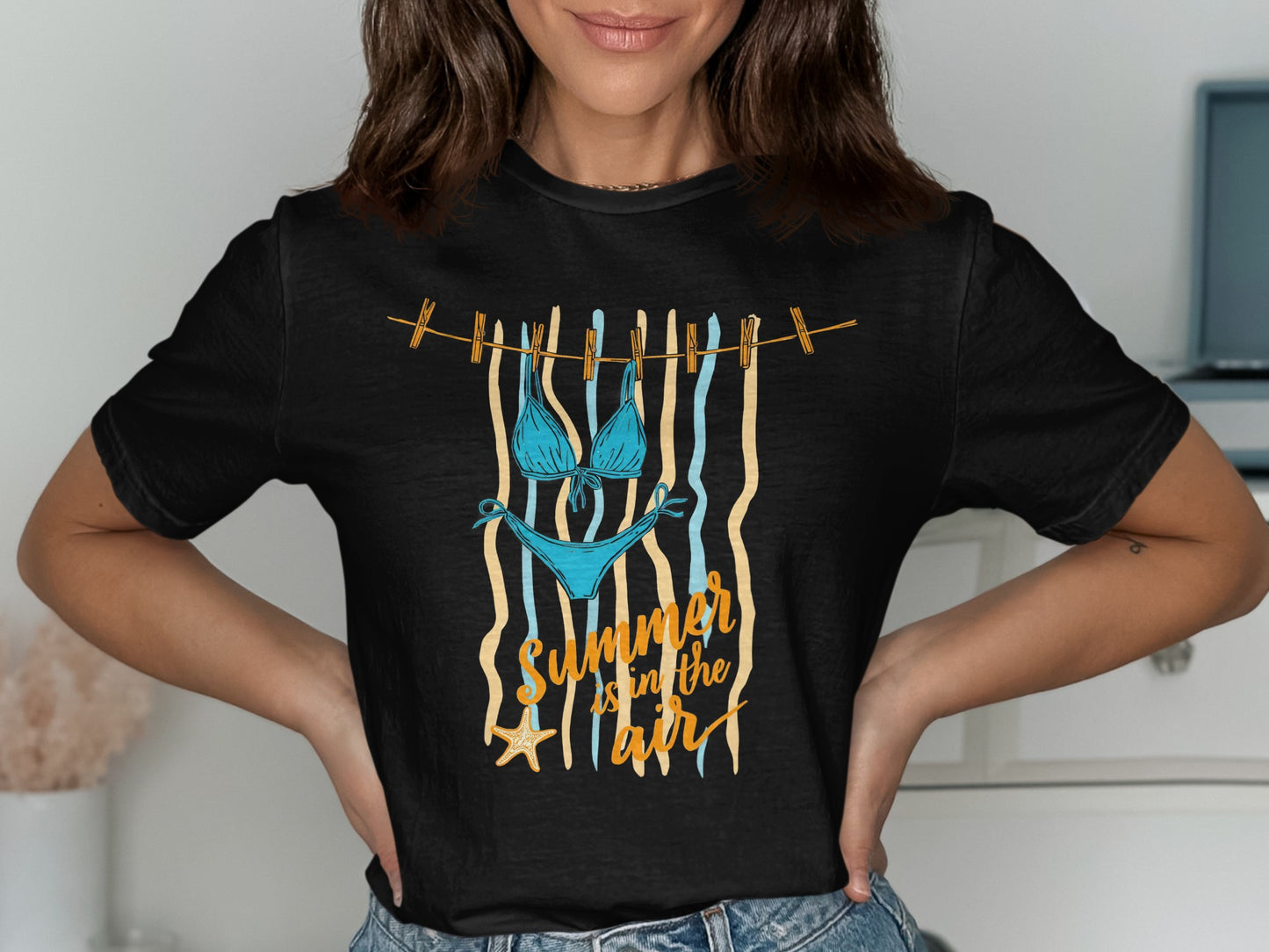 Black t-shirt with a bikini and "Summer in the air" graphic.