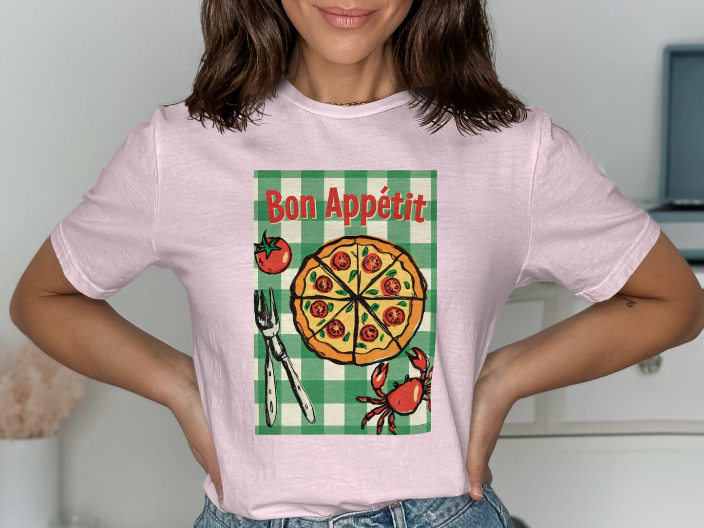 Pink t-shirt with pizza, crab, and fork design, reading "Bon Appétit".