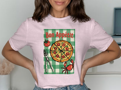 Pink t-shirt with pizza, crab, and fork design, reading "Bon Appétit".