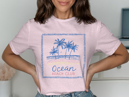 Pink t-shirt with "Ocean Beach Club" text and palm trees graphic.
