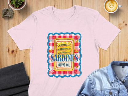 Pink t-shirt with a colorful graphic of a sardines in olive oil can.