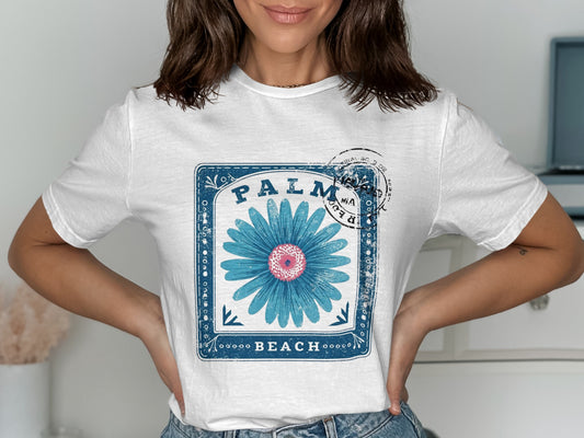 White t-shirt with blue floral graphic and "PALM BEACH" text.