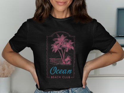 Black t-shirt with pink palm trees and "Ocean Beach Club" text.