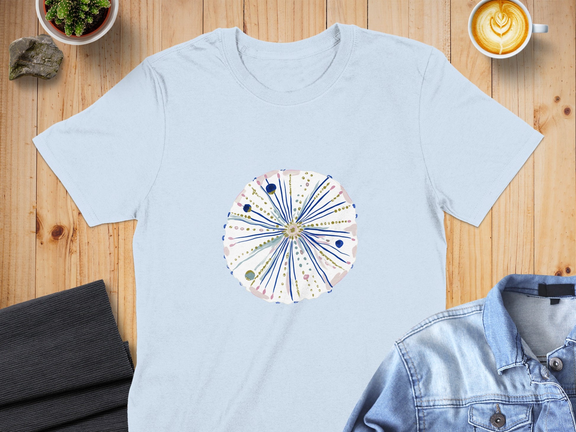 Light blue t-shirt with a round, abstract floral design.