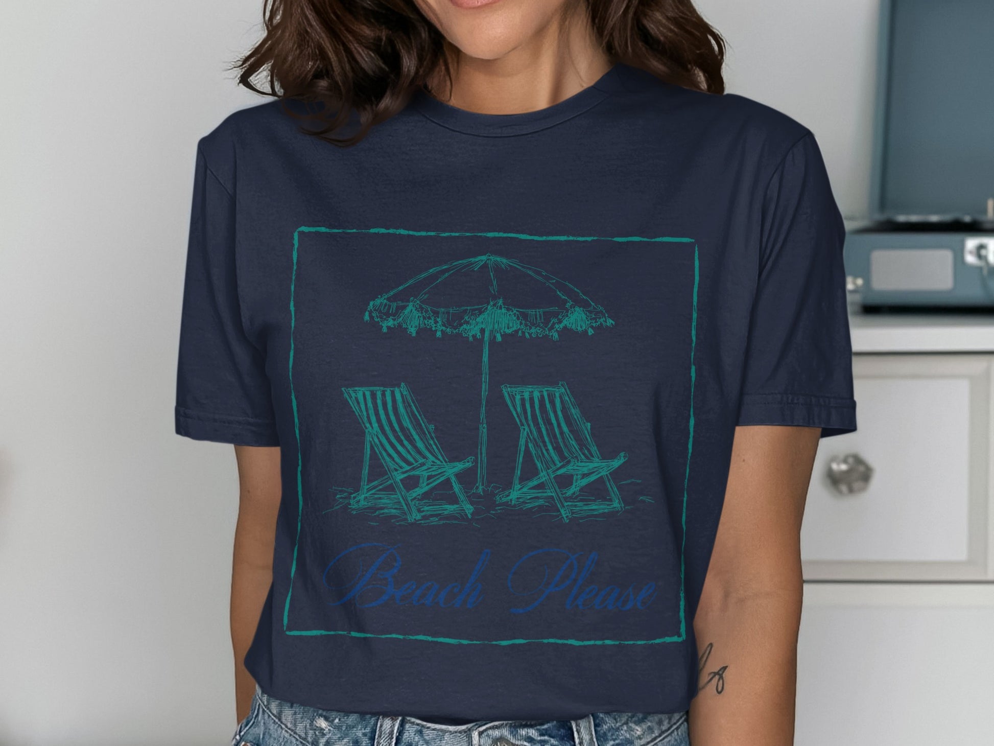 Navy t-shirt with a sketch of beach chairs and umbrella, reading "Beach Please".