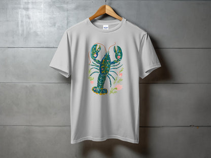 White t-shirt with a blue and green floral lobster design.
