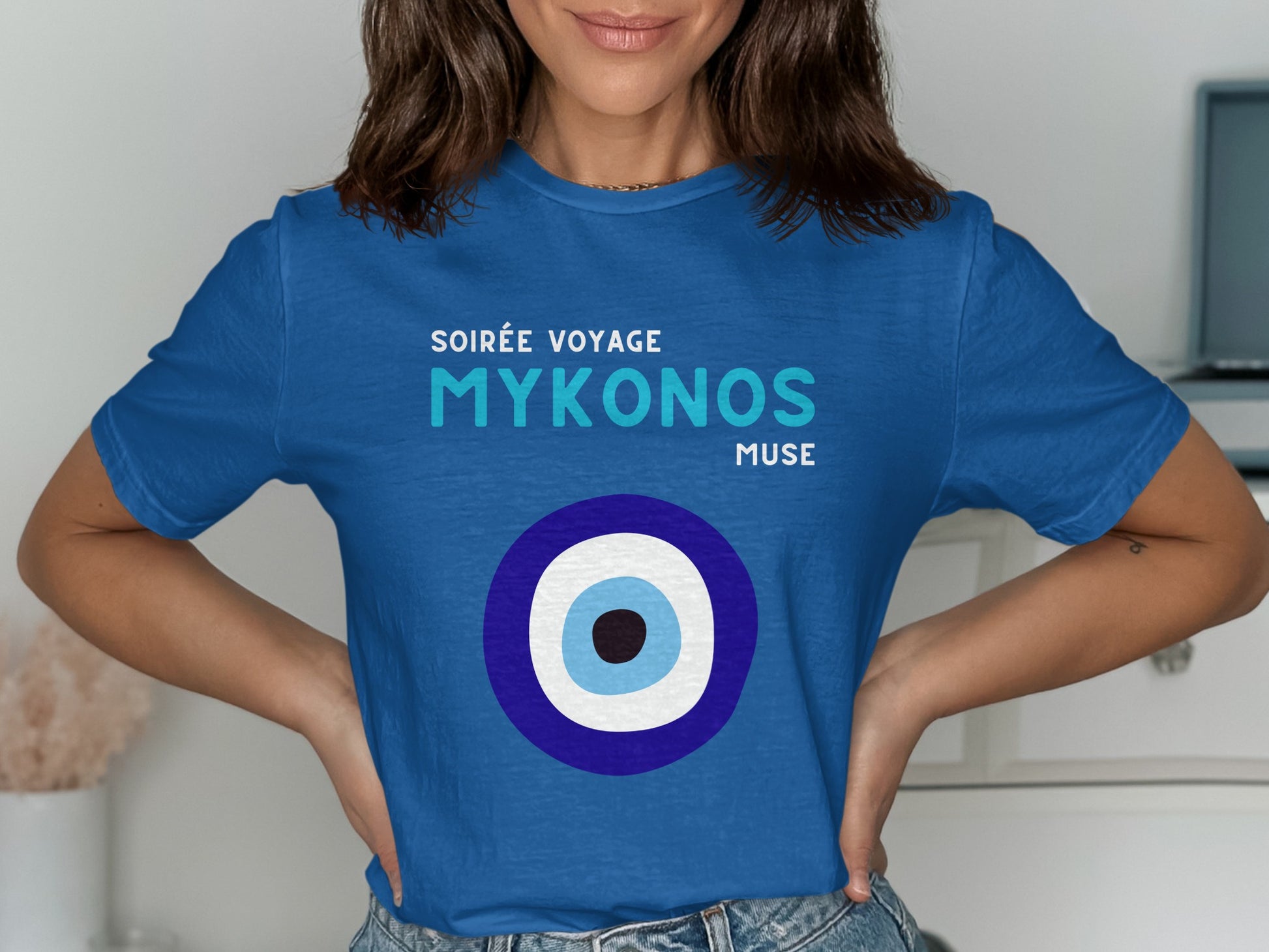 Blue t-shirt with "Soirée Voyage Mykonos Muse" and an evil eye design.