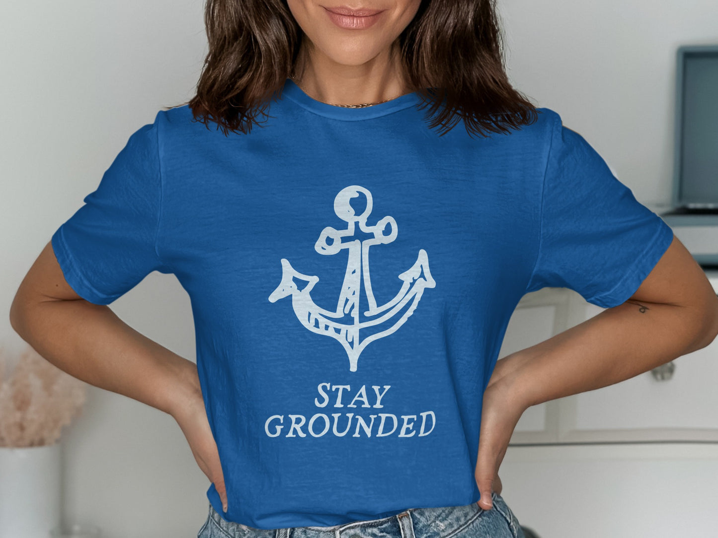 Blue t-shirt with white anchor and "STAY GROUNDED" text.