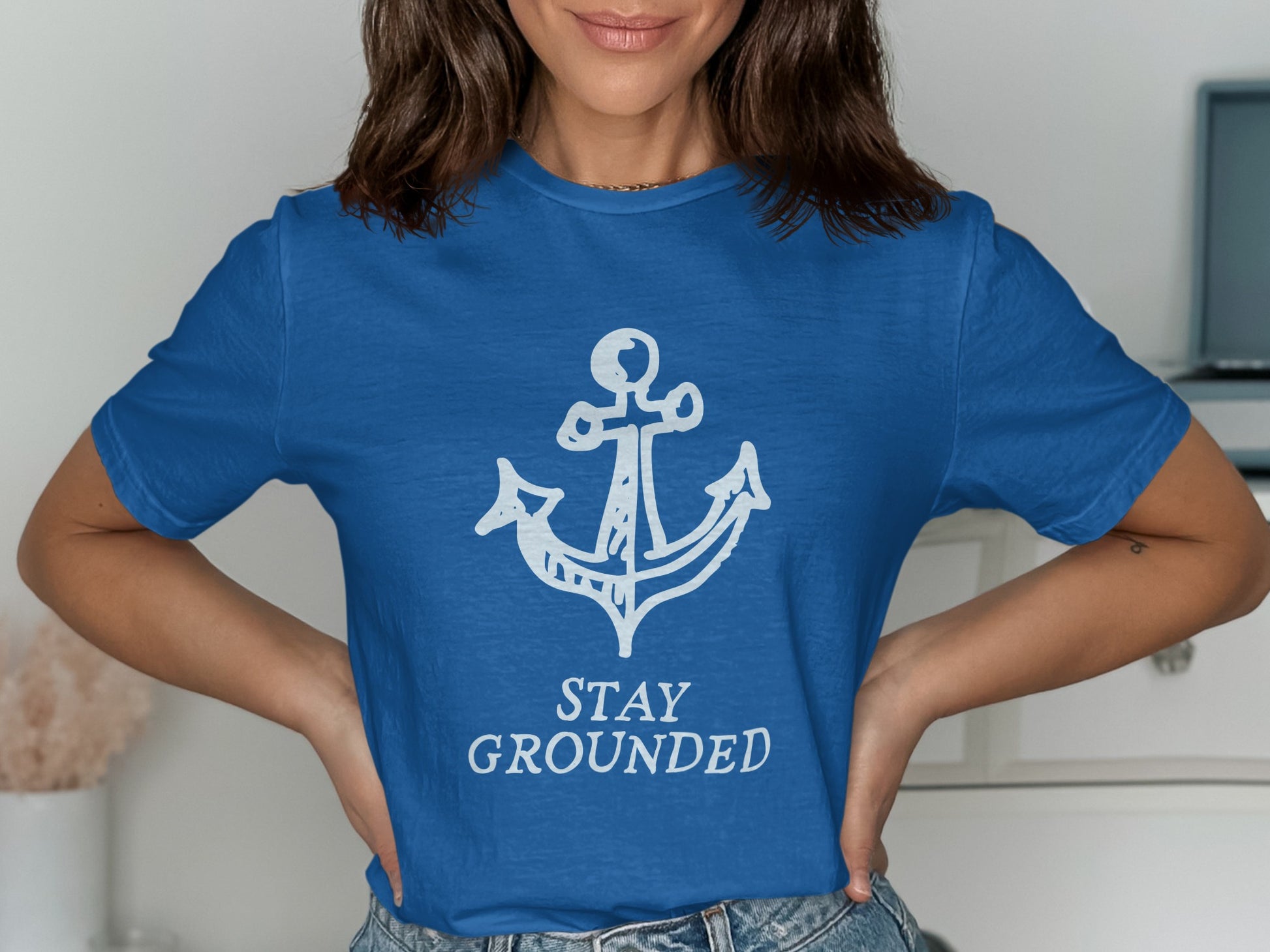 Blue t-shirt with white anchor and "STAY GROUNDED" text.