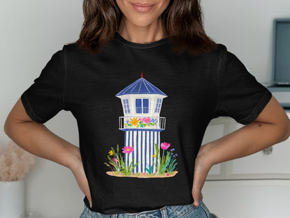 Black t-shirt featuring a watercolor illustration of a blue and white lifeguard tower with flowers.