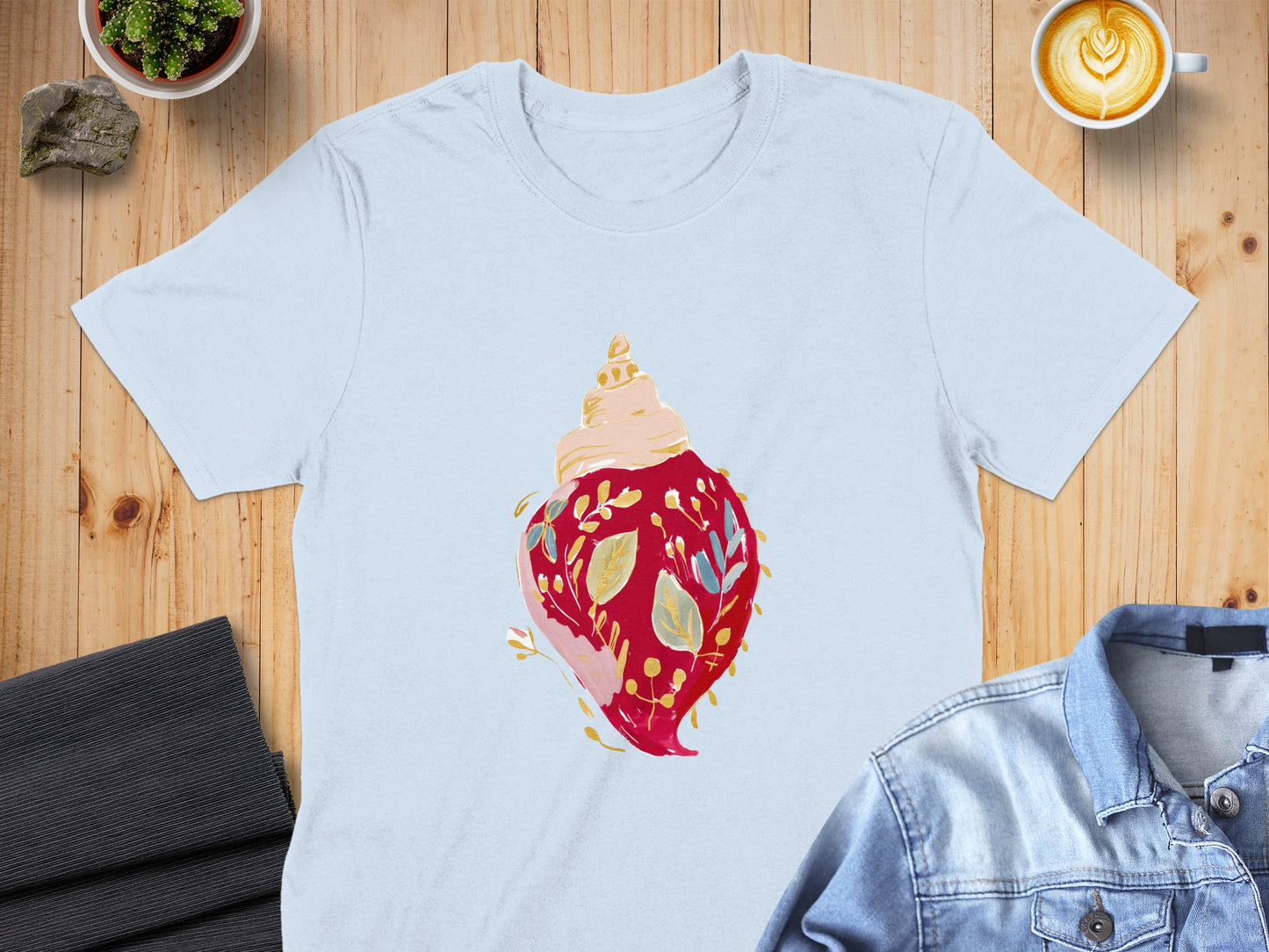 Light blue t-shirt with a red seashell and floral design.