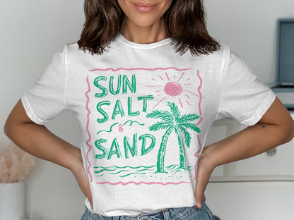 White t-shirt with "SUN SALT & SAND" and a palm tree design.