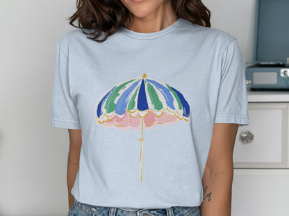 Light blue t-shirt with a colorful beach umbrella graphic.