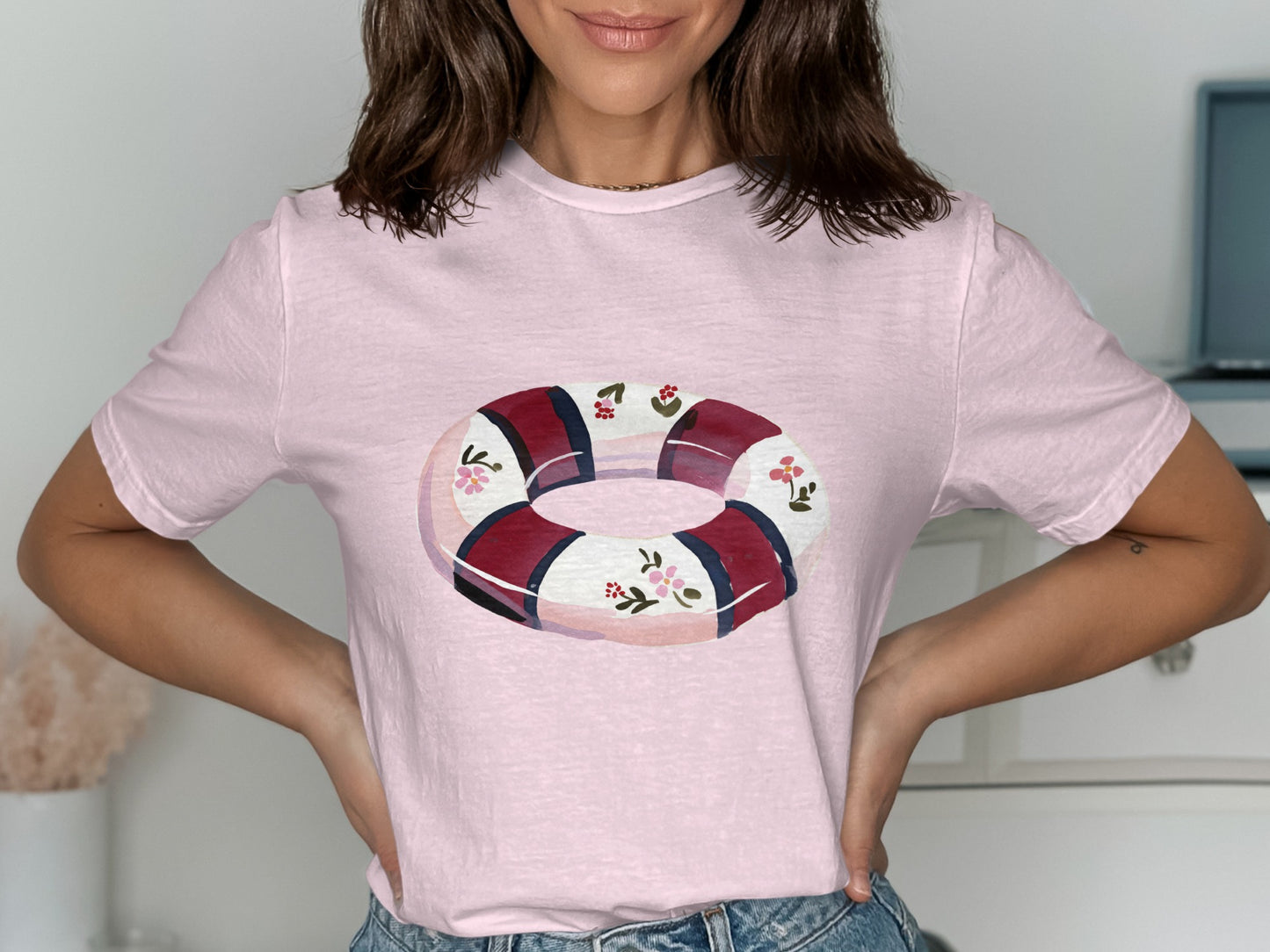Pink t-shirt with a floral life preserver graphic.