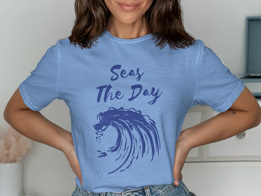 Light blue t-shirt with "Seas The Day" text and a blue wave graphic.