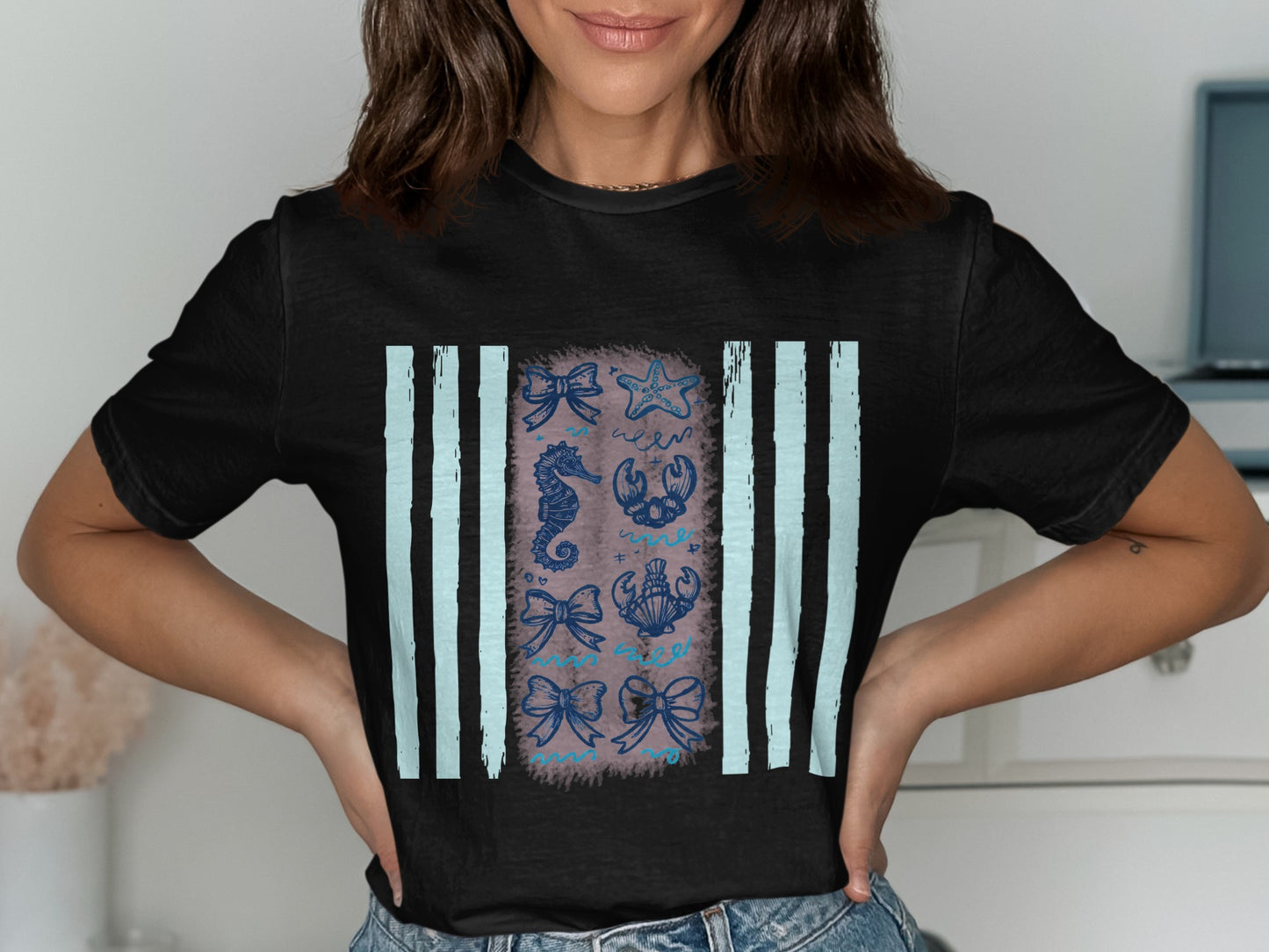 Black t-shirt with nautical motifs including seahorses, starfish, and bows.