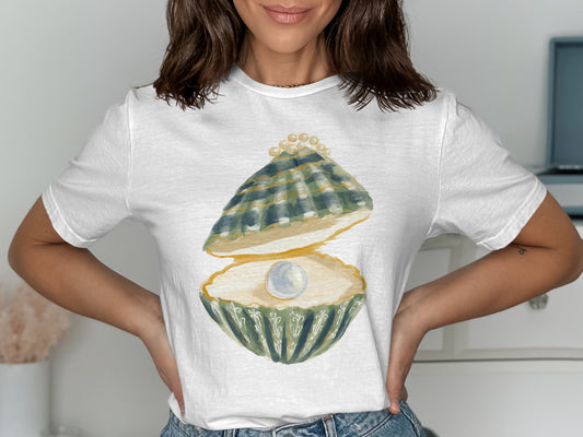 White t-shirt with a watercolor illustration of an open oyster revealing a pearl and smaller pearls.