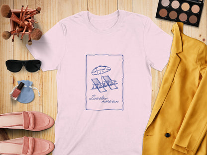 White t-shirt with "Live slow more sun" text and beach chairs graphic.
