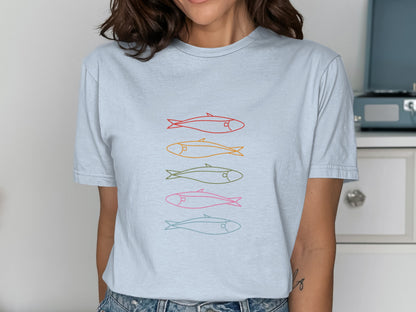 T-shirt with colorful fish illustrations in orange, yellow, green, and pink.