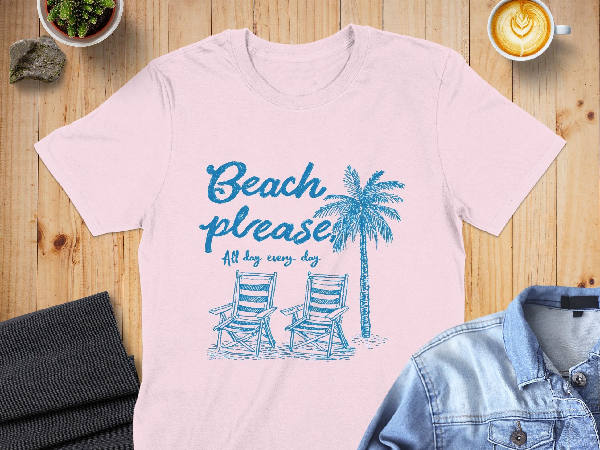 Pink t-shirt with "Beach please all day every day" and palm tree graphic.