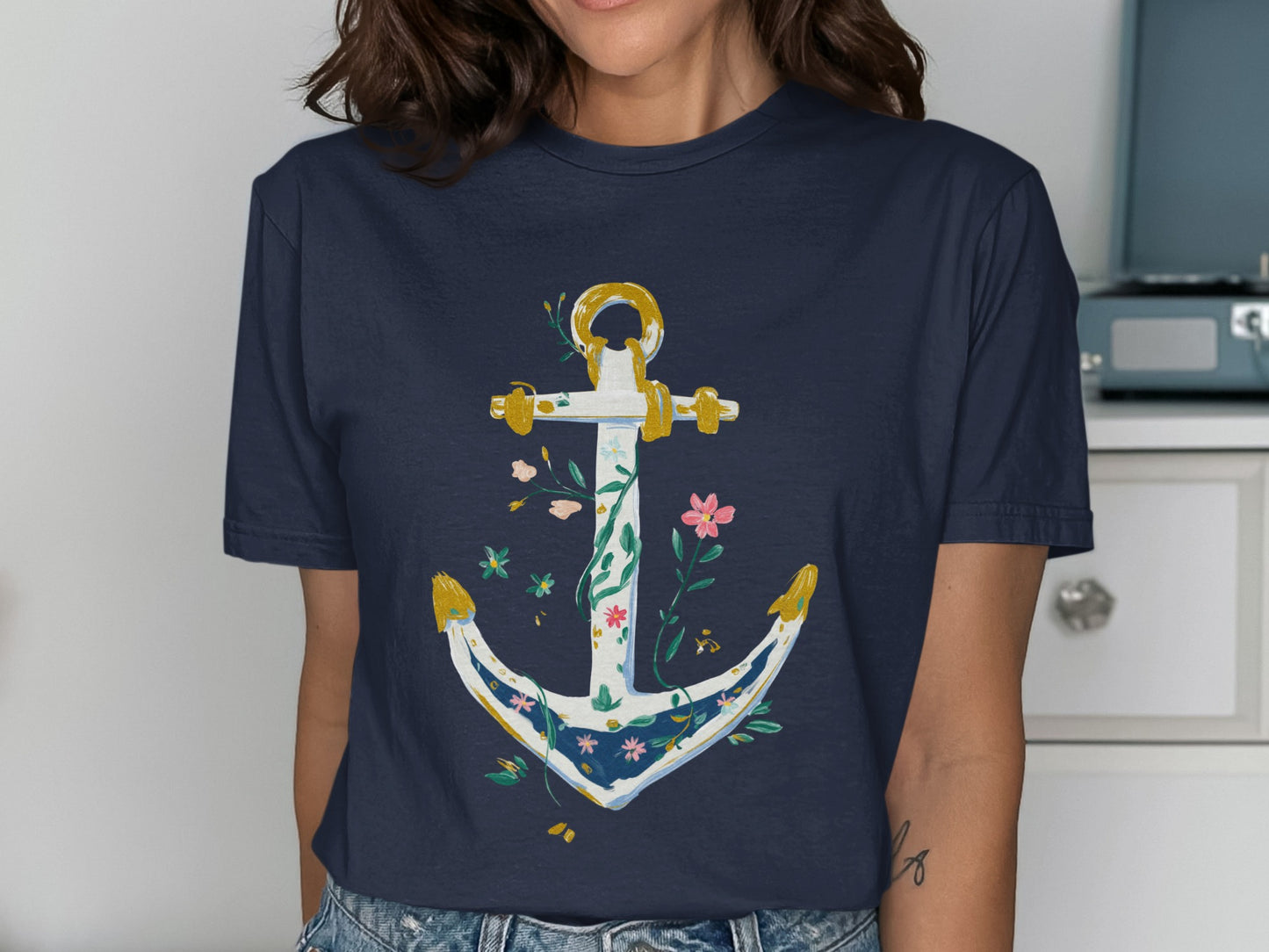 Navy t-shirt with white anchor adorned with colorful flowers and leaves.