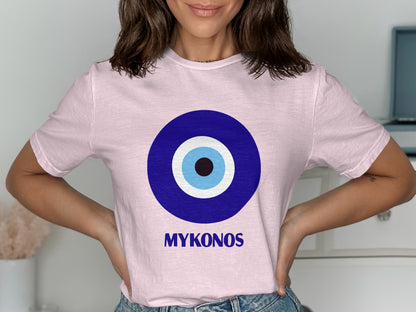 Pink t-shirt with a blue evil eye design and "MYKONOS" text.