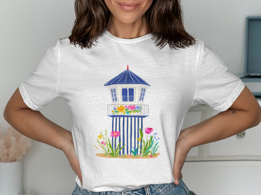 White t-shirt with a graphic of a blue and white lifeguard tower with flowers.