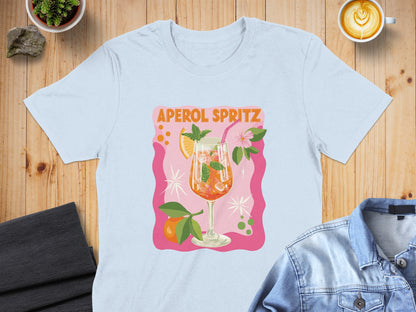 Aperol Spritz graphic on a light blue t-shirt with orange slices and mint.