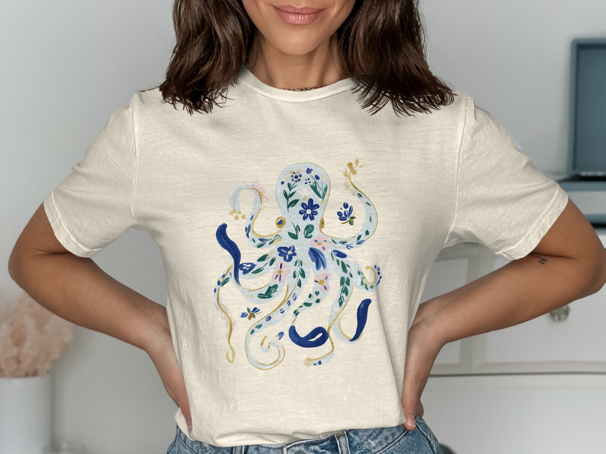 Cream t-shirt with a blue floral octopus design.