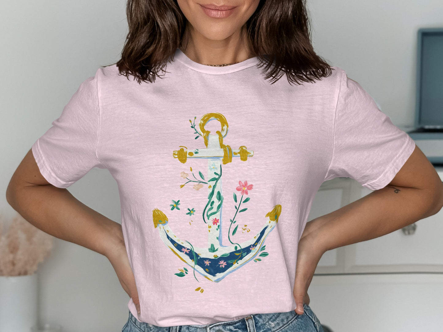 Pink t-shirt with an anchor design featuring floral and vine accents.