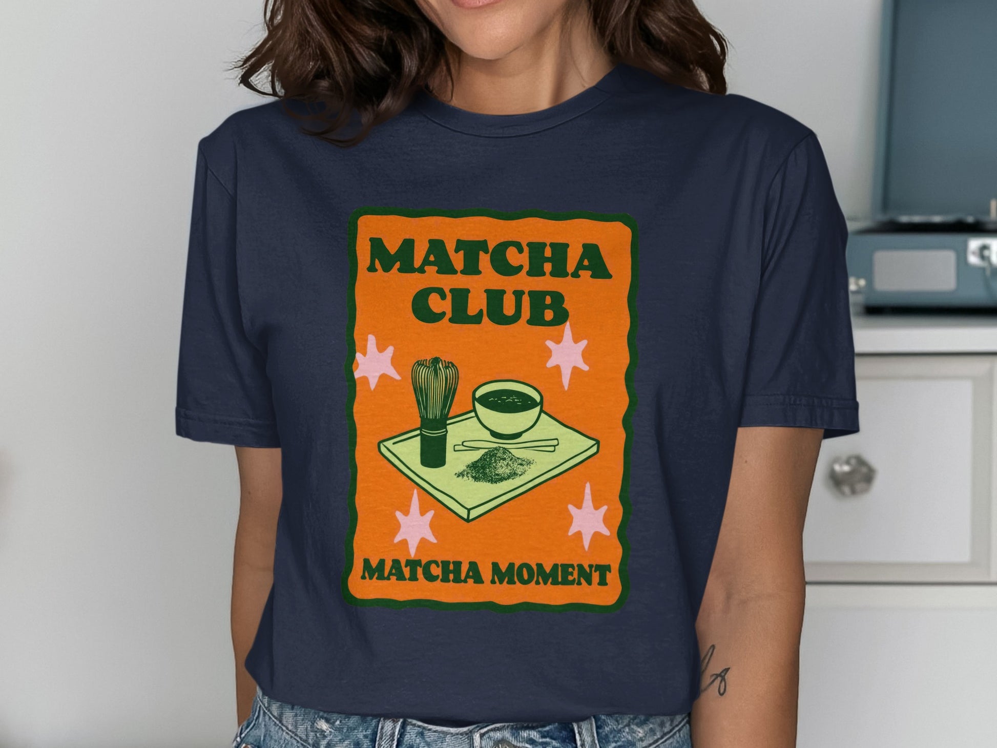 Navy t-shirt with "Matcha Club Matcha Moment" and matcha tea set illustration.